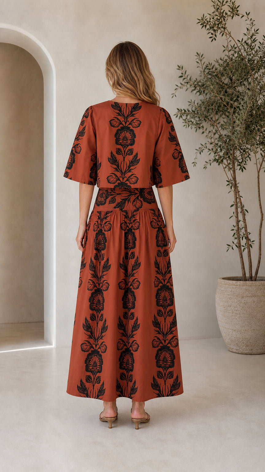 Back view of rust floral print matching top and tiered maxi skirt set
