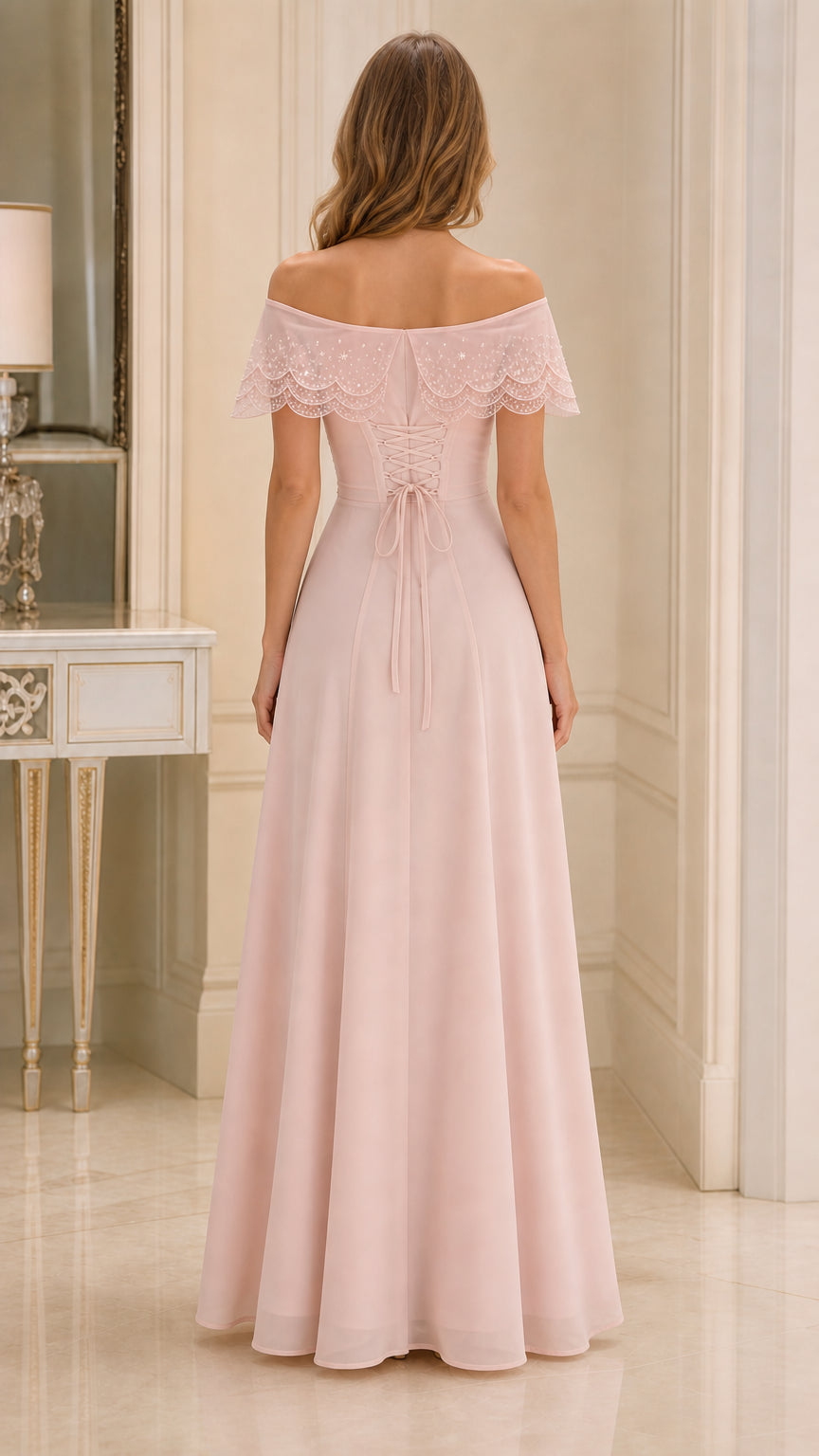 Back view of blush pink gown showing lace-up corset back and flowing skirt