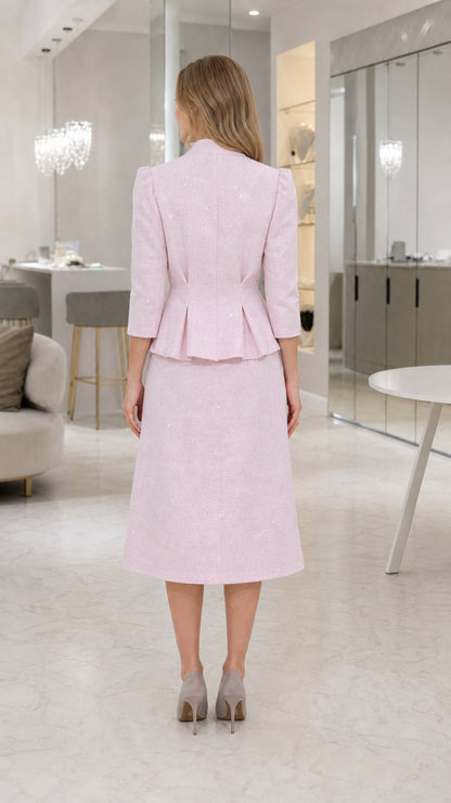 Back view of tailored blush pink peplum jacket and midi skirt