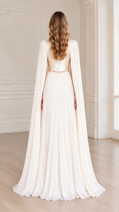 Back view of ivory floor-length gown with flowing pleated cape
