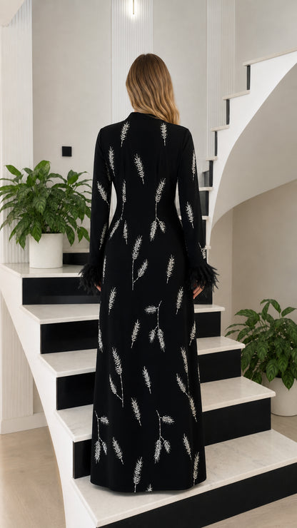 Back view of black floor length dress showing graceful silhouette