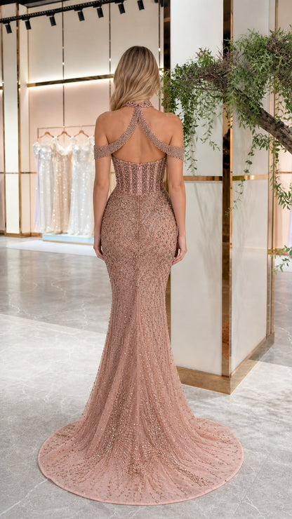 Back view of model showing open back and train on dusty rose formal gown