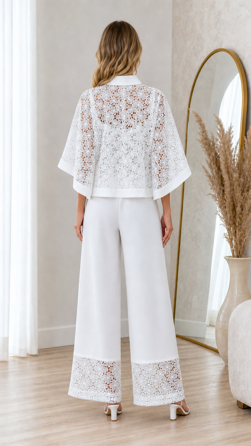 Back view of model in white floral crochet lace top and wide leg pants