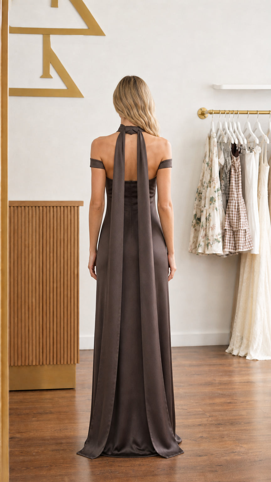Back view of chocolate brown satin maxi dress showing long flowing neck scarf drape