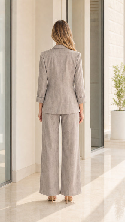 Back view of woman wearing light grey wide-leg pants suit