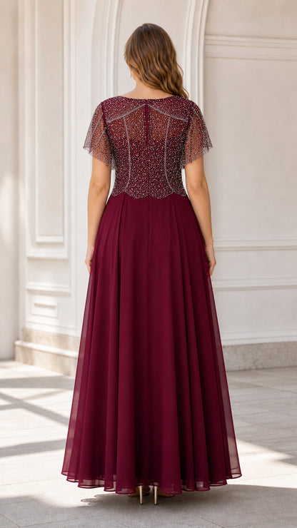 Back view of model wearing burgundy chiffon gown showing elegant back bodice details