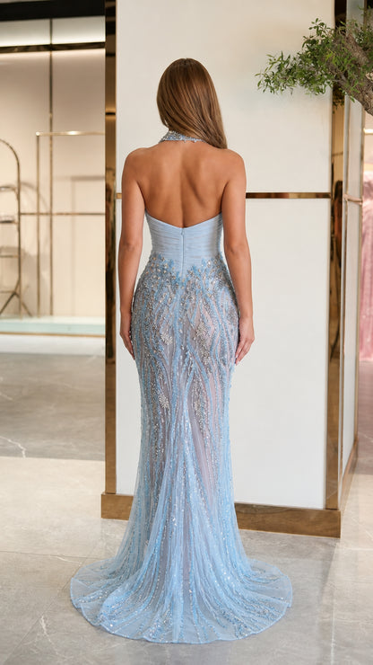 Back view of model in light blue halter backless evening gown with detailed beadwork