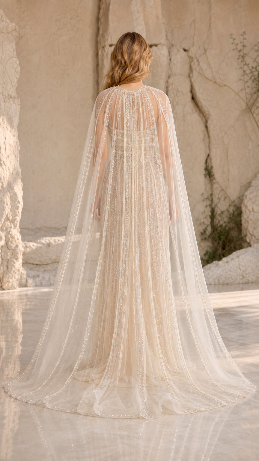 Back view of floor-length champagne evening gown highlighting the sheer tulle cape train