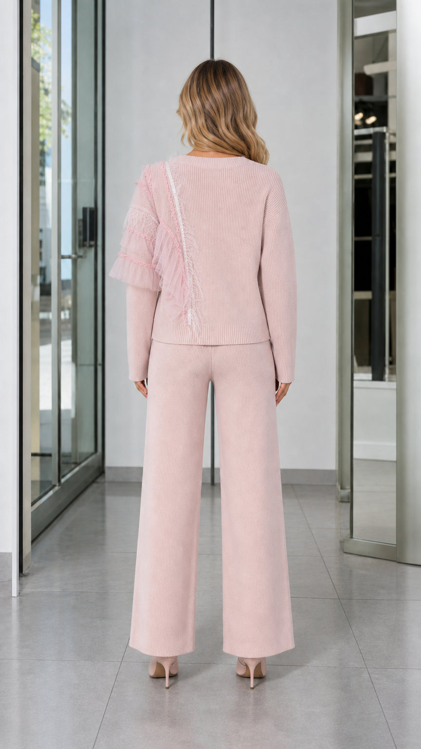 Back view of woman wearing Light Pink knit lounge sweater and drawstring wide-leg pants