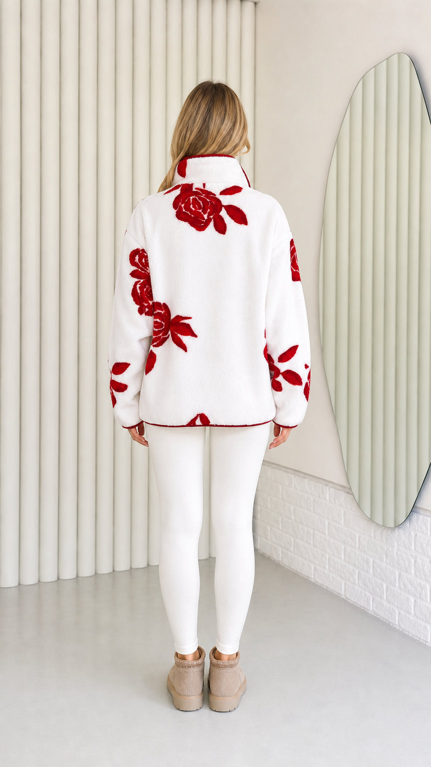 Back view of model wearing white and red floral plush fleece jacket