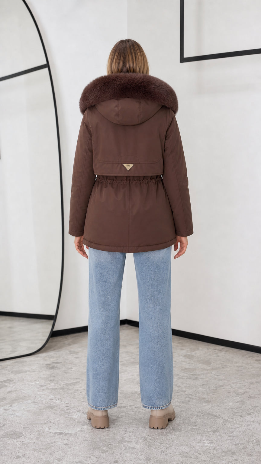 Back view of women's chocolate brown hooded winter coat with cinch waist