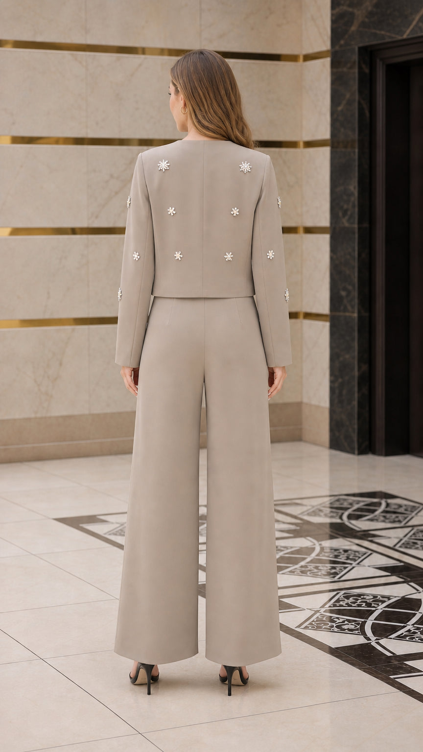 Back view of taupe cropped jacket and wide-leg trousers ensemble