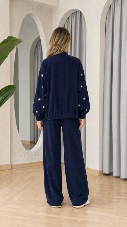 Model wearing Navy Blue wide leg pants and zip jacket set, back view