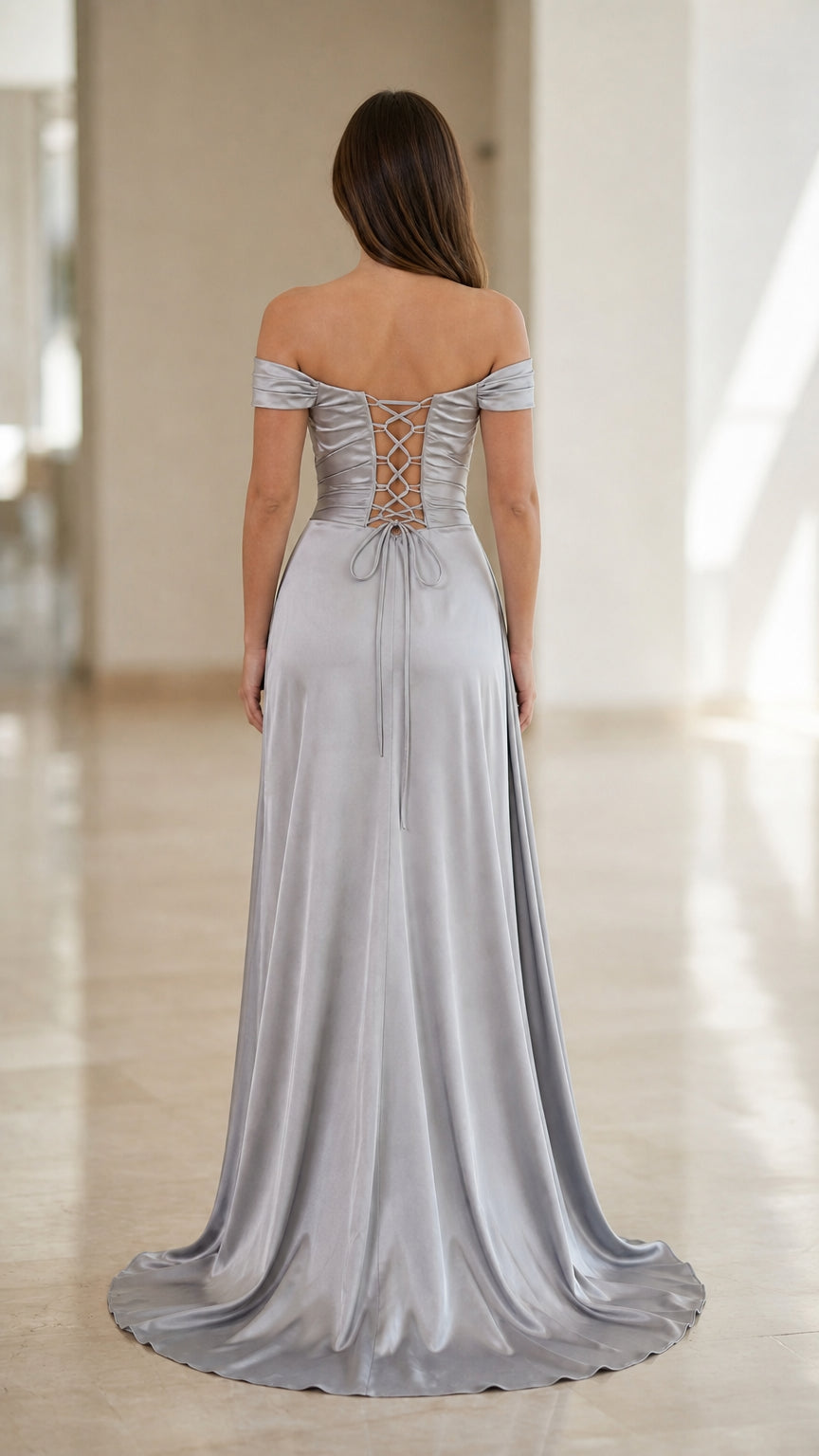 Back view of silver satin gown highlighting adjustable corset lace-up closure