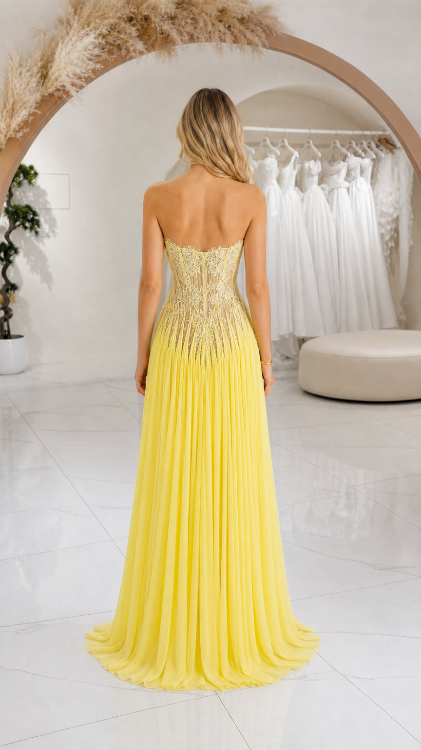 Back view of yellow strapless evening gown showing low open back