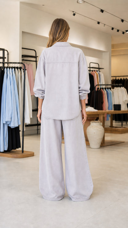 Back view of women's light grey long-sleeve shirt and wide-leg pants set