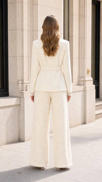 Back view of model wearing Cream belted blazer and wide-leg trousers