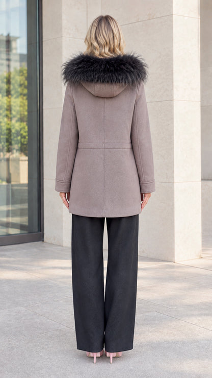 Back view of model showing hood with faux fur trim and mid-thigh coat length