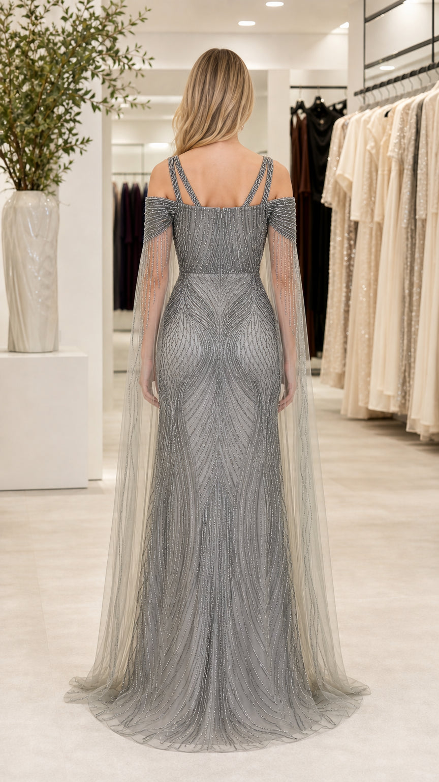 Back view of silver beaded evening gown with double straps and trailing capelet