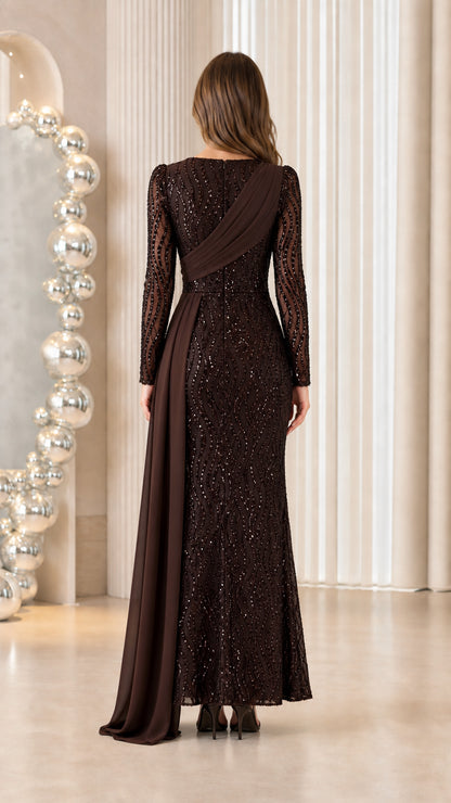 Back view of woman wearing chocolate brown long sleeve sequined maxi dress with draped shoulder detail