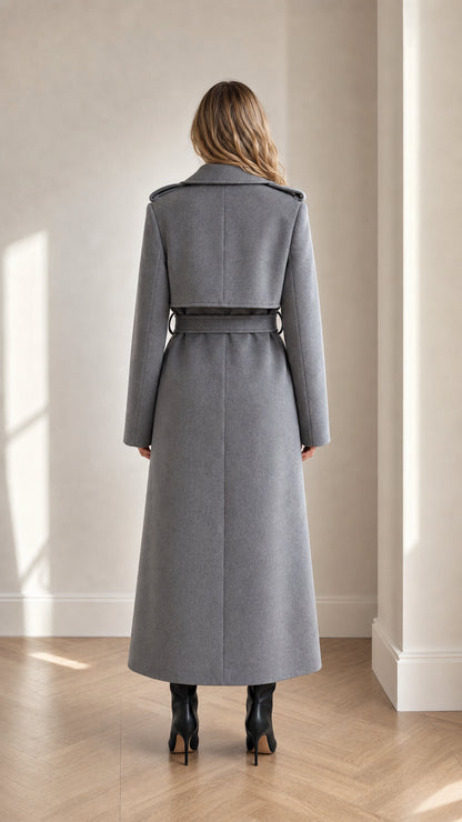 Back view of grey maxi trench coat showing shoulder storm flap and belted waist