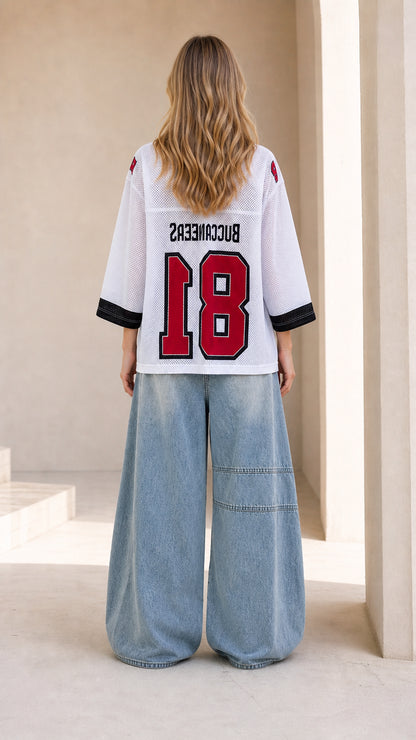 Back view of white oversized number 18 athletic jersey top