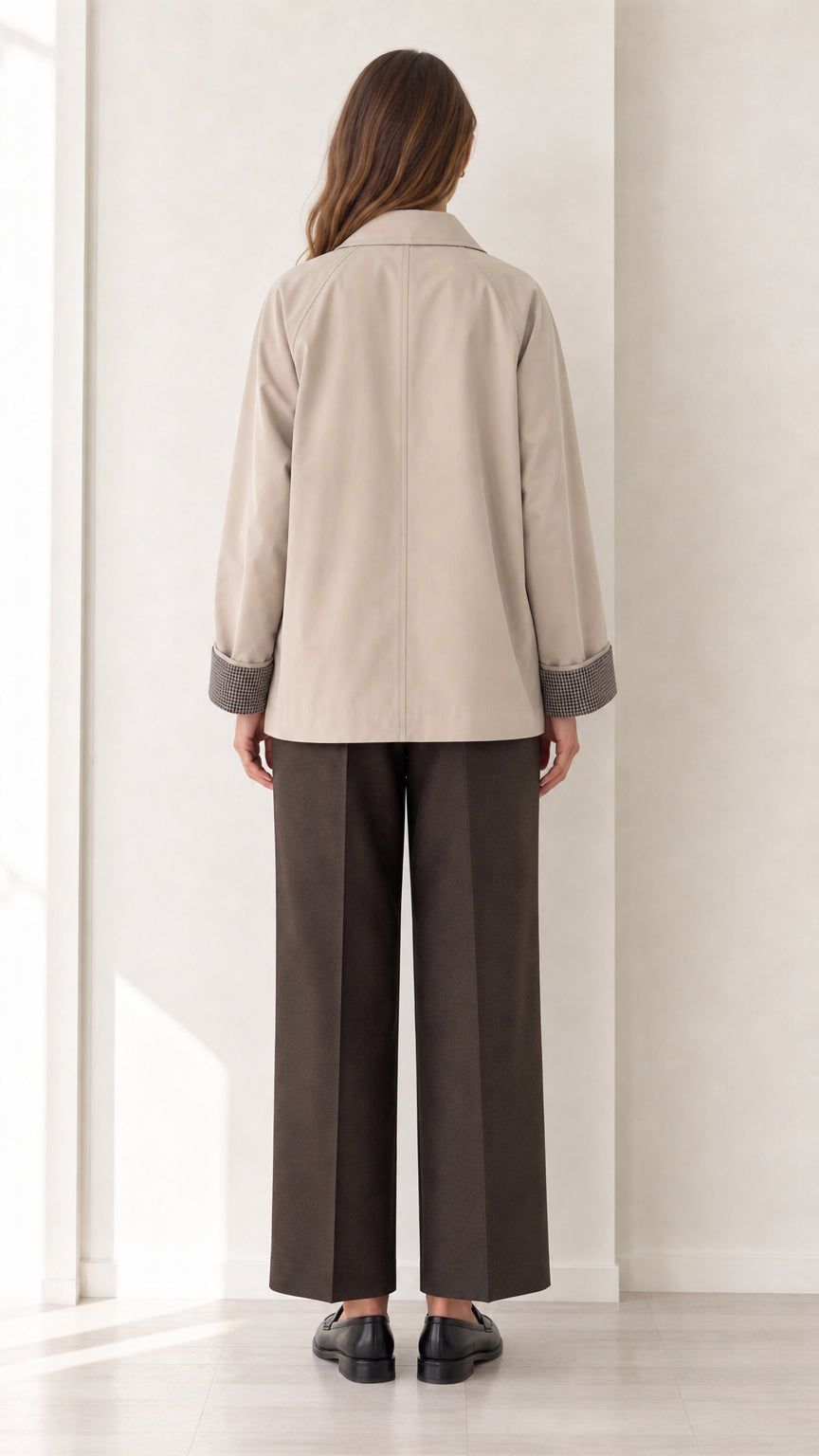 Back view of women's beige short trench jacket showing clean tailoring