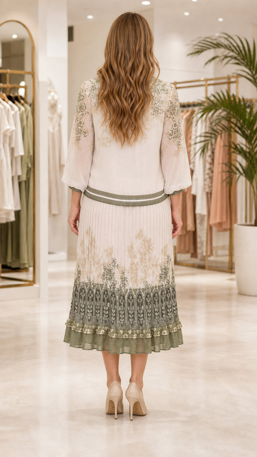 Back view of model wearing cream pleated midi skirt set with floral details