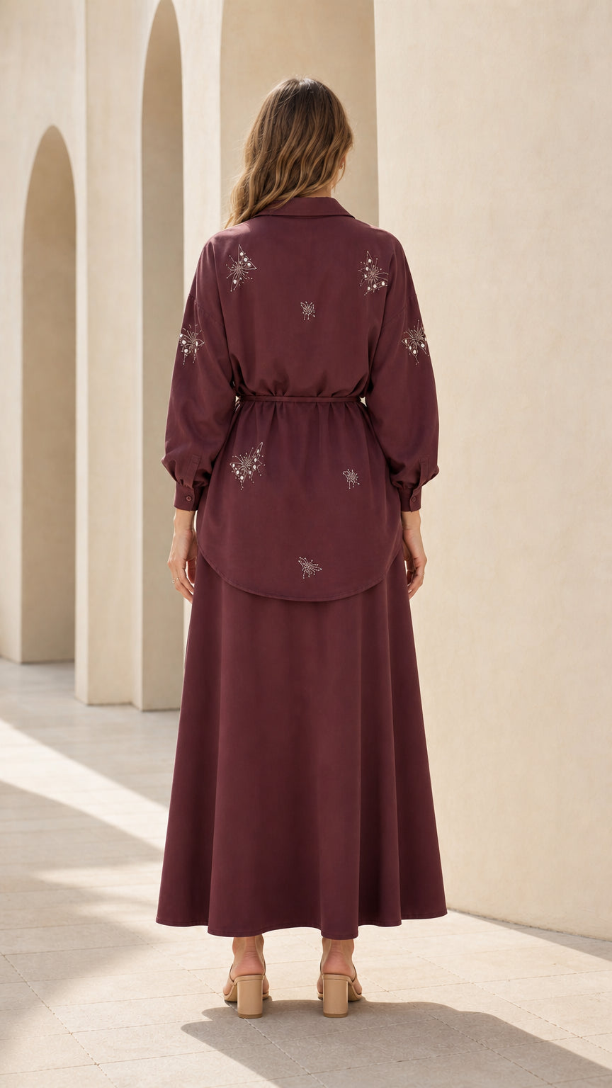 Back view of woman wearing burgundy matching tunic and maxi skirt set