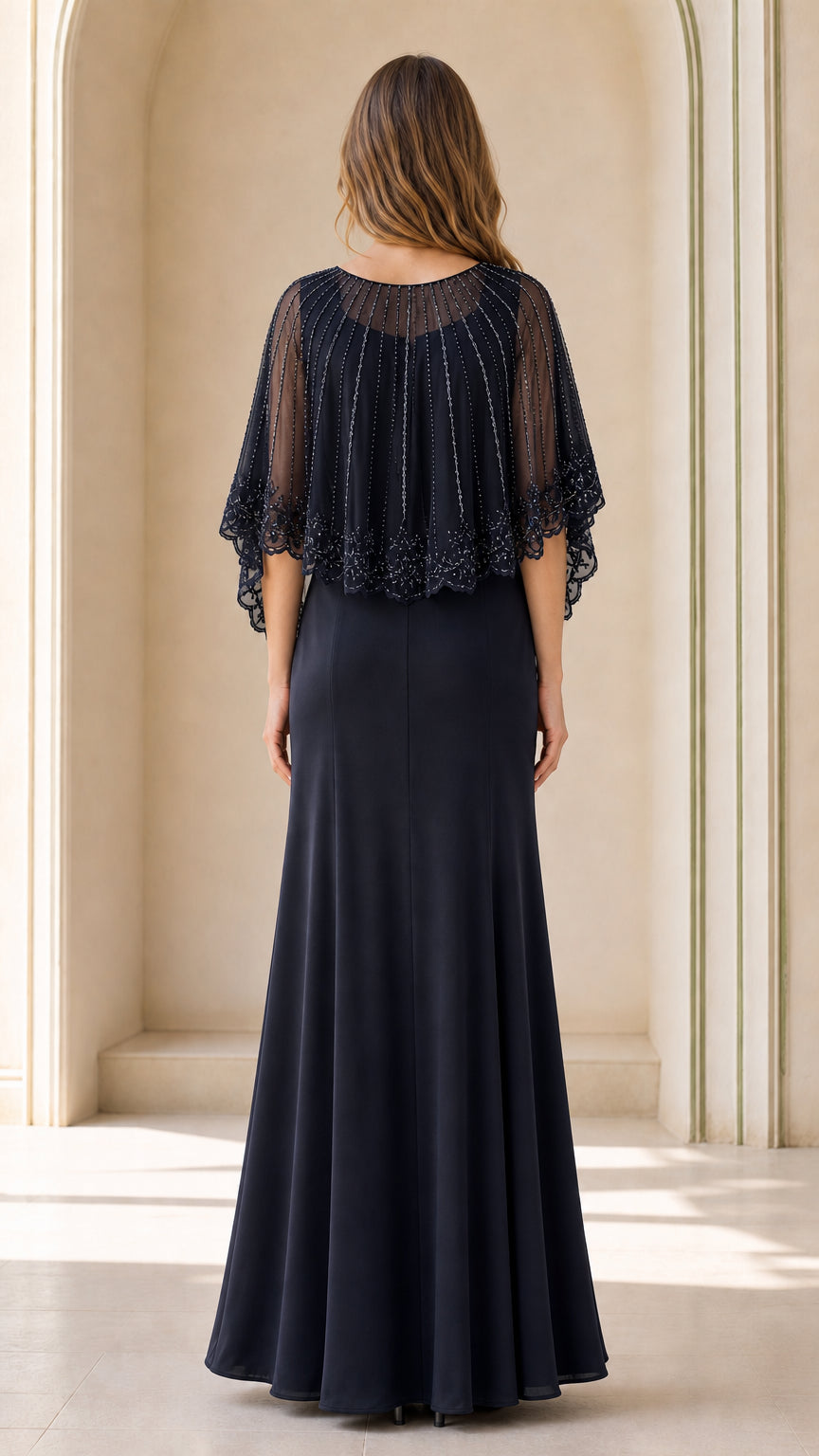 Back view of navy blue maxi evening gown with beaded mesh capelet