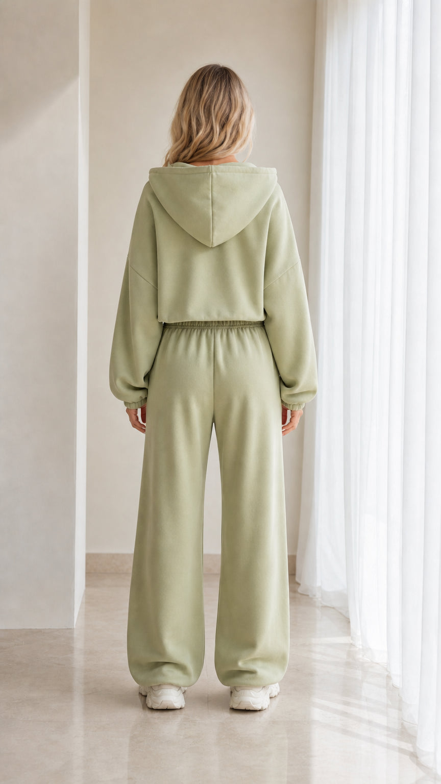 Back view of model in sage green hooded loungewear set