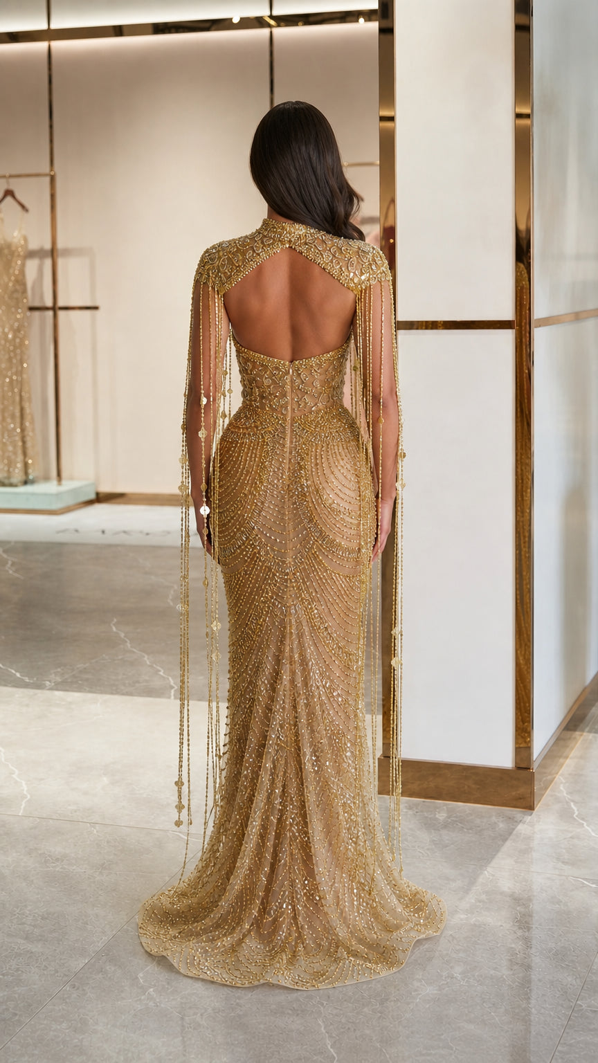Open back view of gold embellished mermaid gown with trailing hem