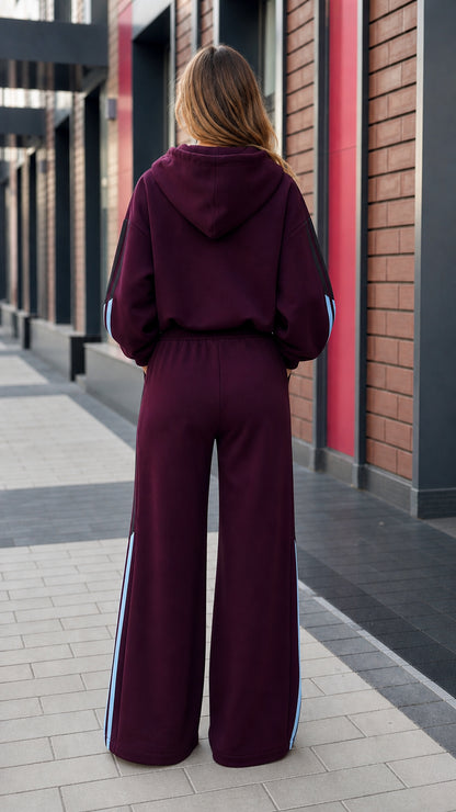 Back view of women's burgundy wide-leg tracksuit set with hooded jacket
