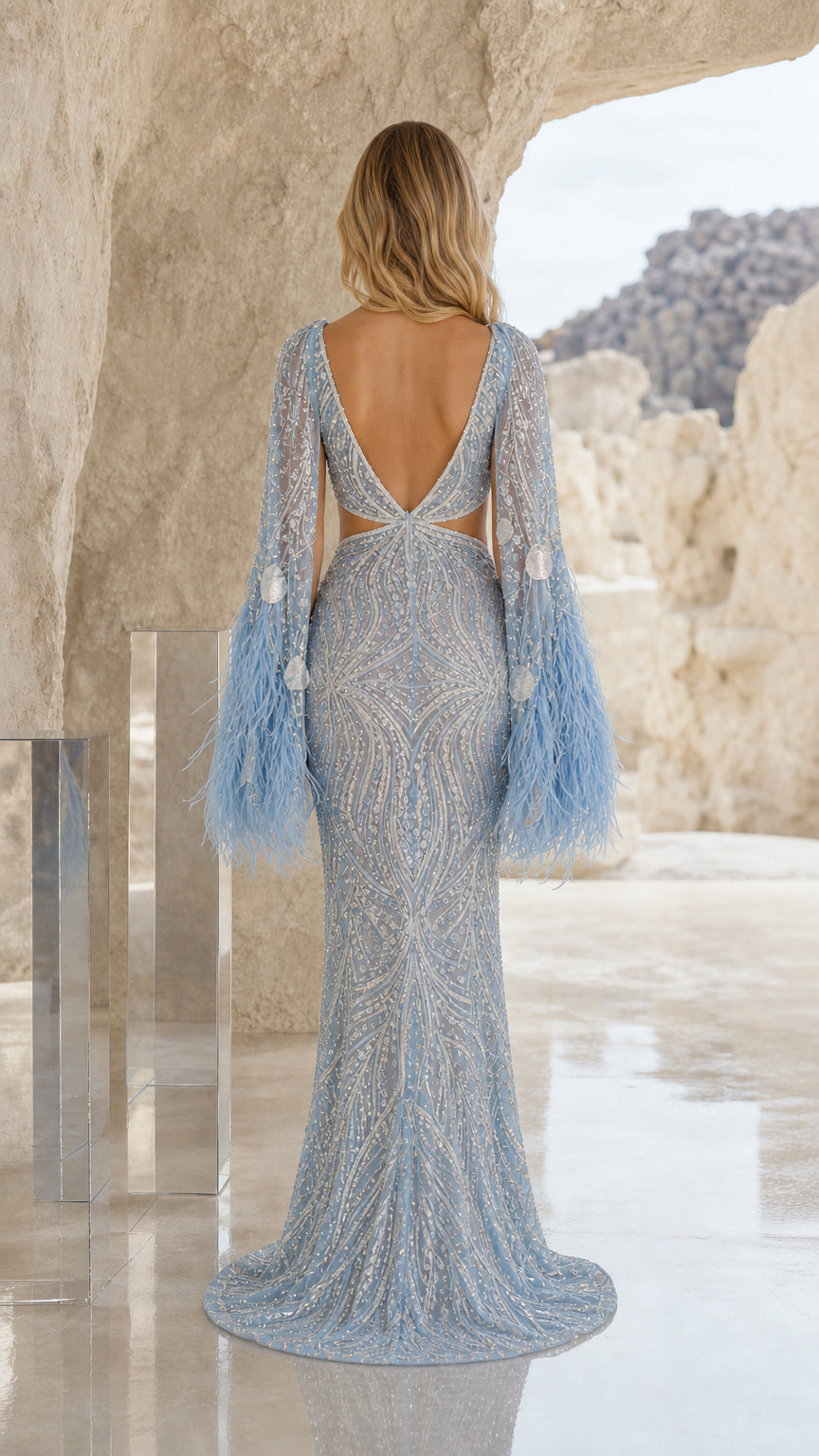 Back view of light blue formal gown highlighting open back and flowing train