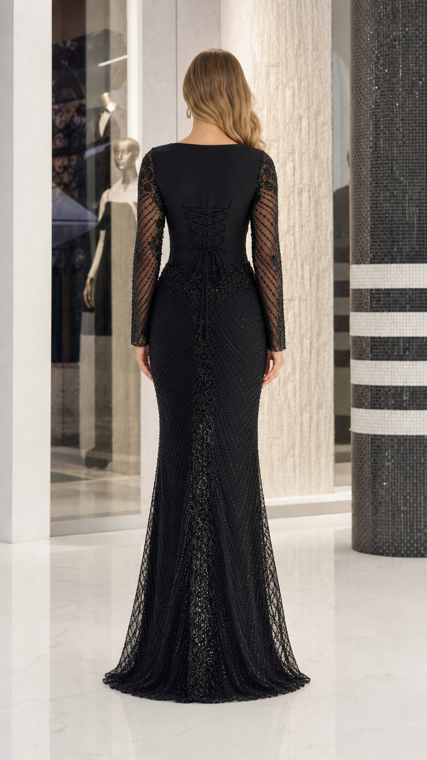 Back view of long sleeve black evening gown showing corset lace detailing