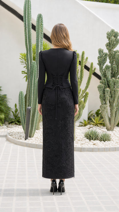 Back view of black evening set highlighting adjustable corset lace-up waist detail