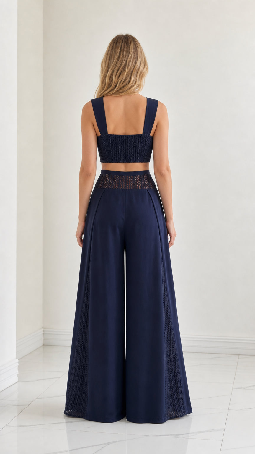 Back view of model wearing Navy Blue crop top and high-waisted wide-leg pants