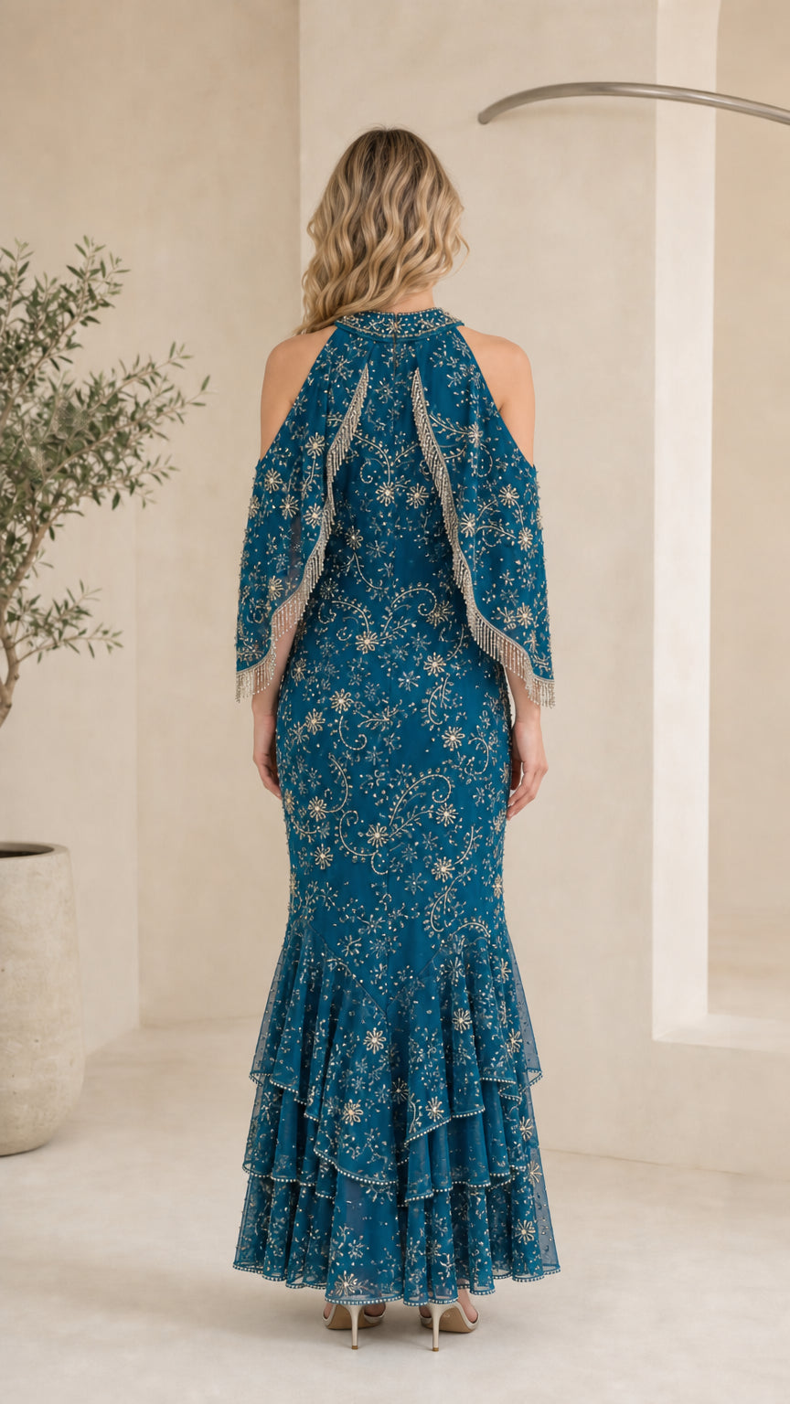 Back view of model showcasing embellished back and cold shoulder details of Teal Blue gown