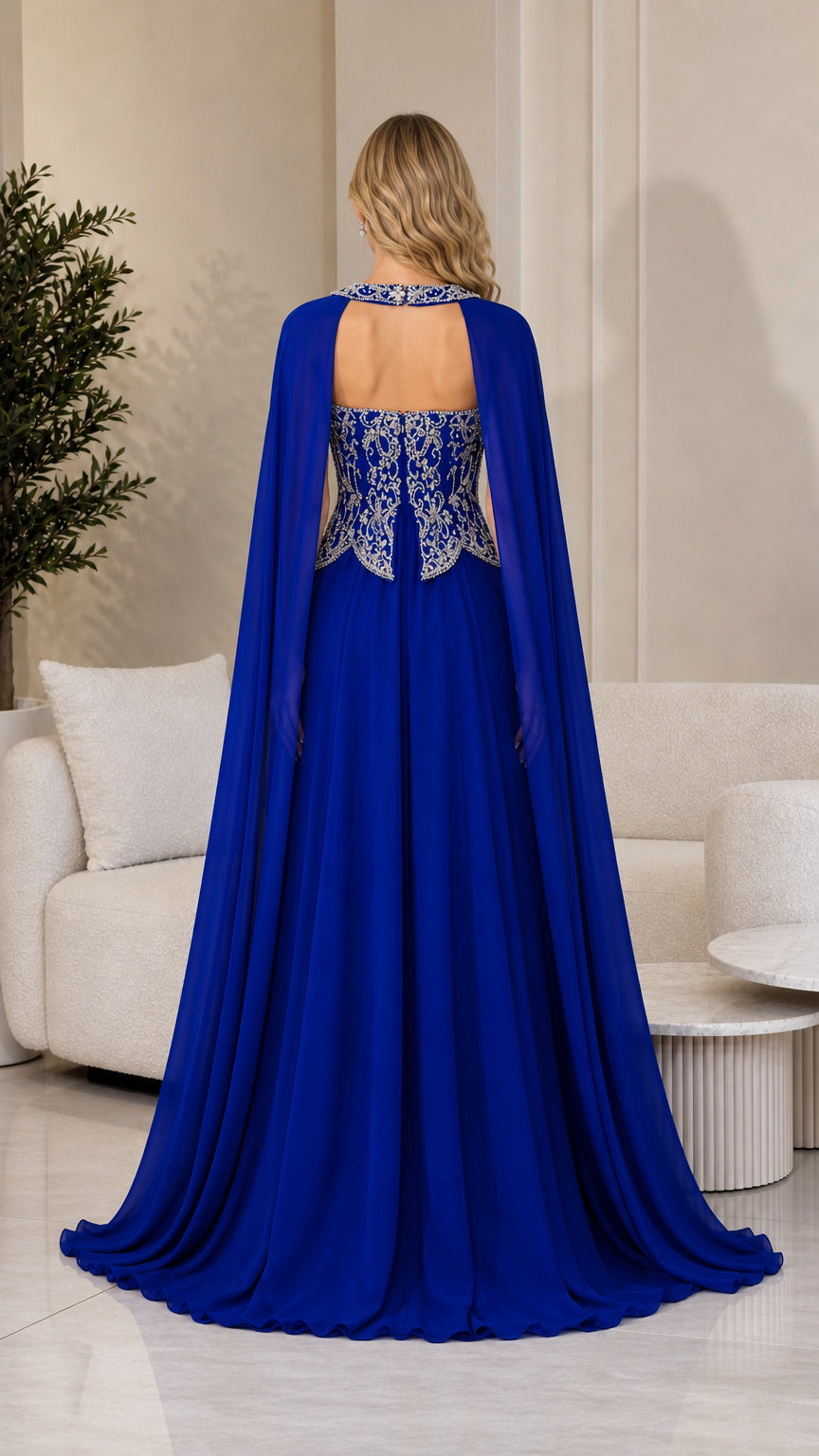 Back view of royal blue cape gown displaying floor-length drape
