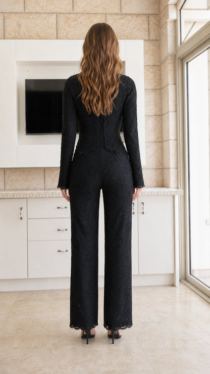 Back view of woman wearing black formal lace two-piece evening set
