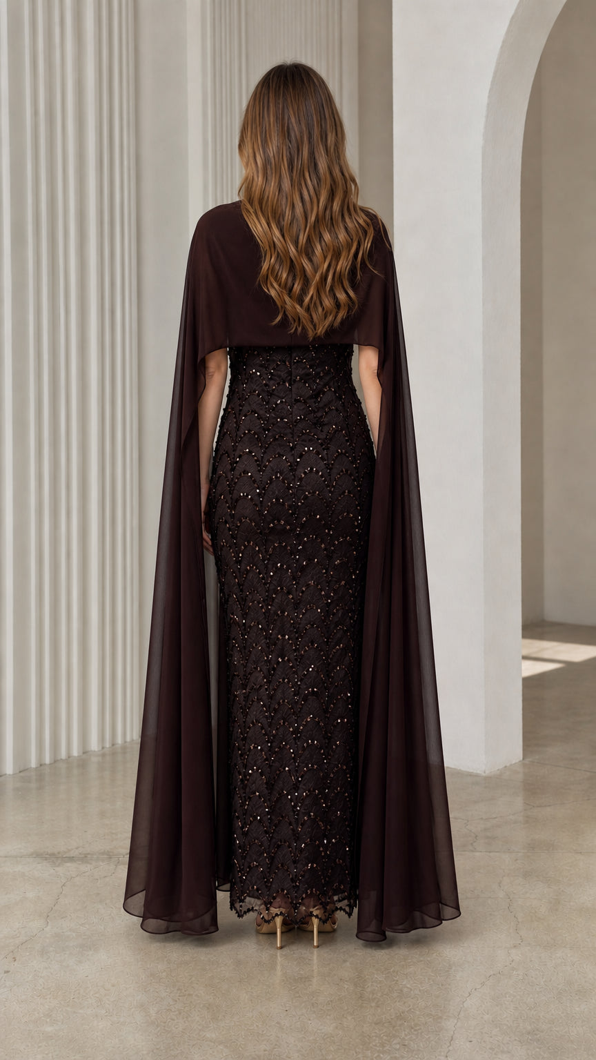 Back view of dark brown formal maxi gown highlighting floor-length cape overlay