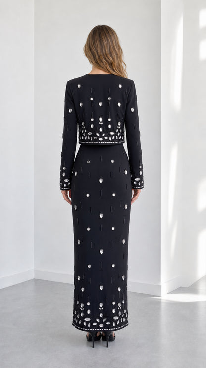 Back view of black rhinestone embellished two-piece evening set showing column skirt