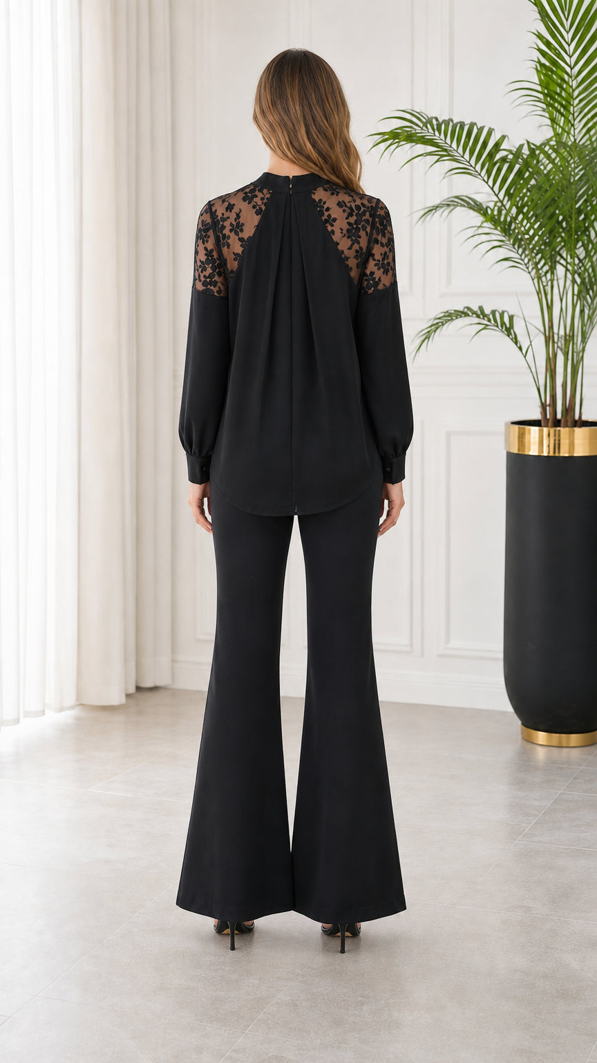 Back view of model wearing black lace back yoke top and high waist flare trousers