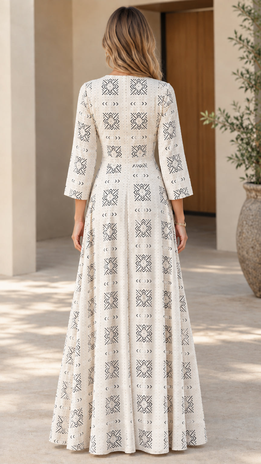Back view of woman wearing off-white geometric pattern maxi dress with 3/4 sleeves