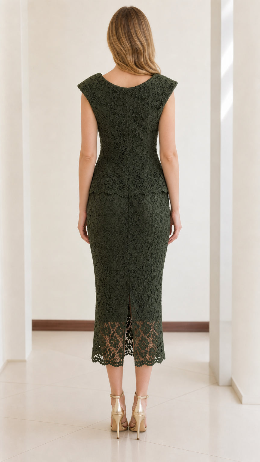 Back view of woman wearing dark green lace midi dress with back slit