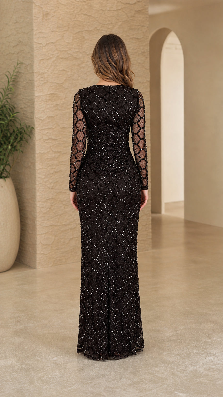 Back view of black long sleeve sequin column formal gown