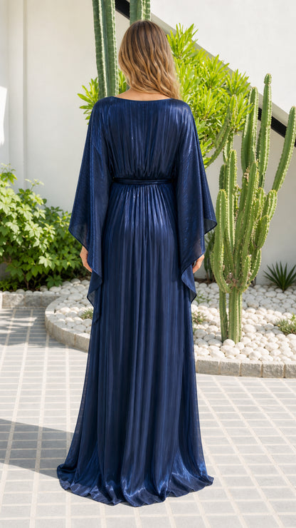 Back view of model wearing Navy Blue pleated maxi gown with cape sleeves
