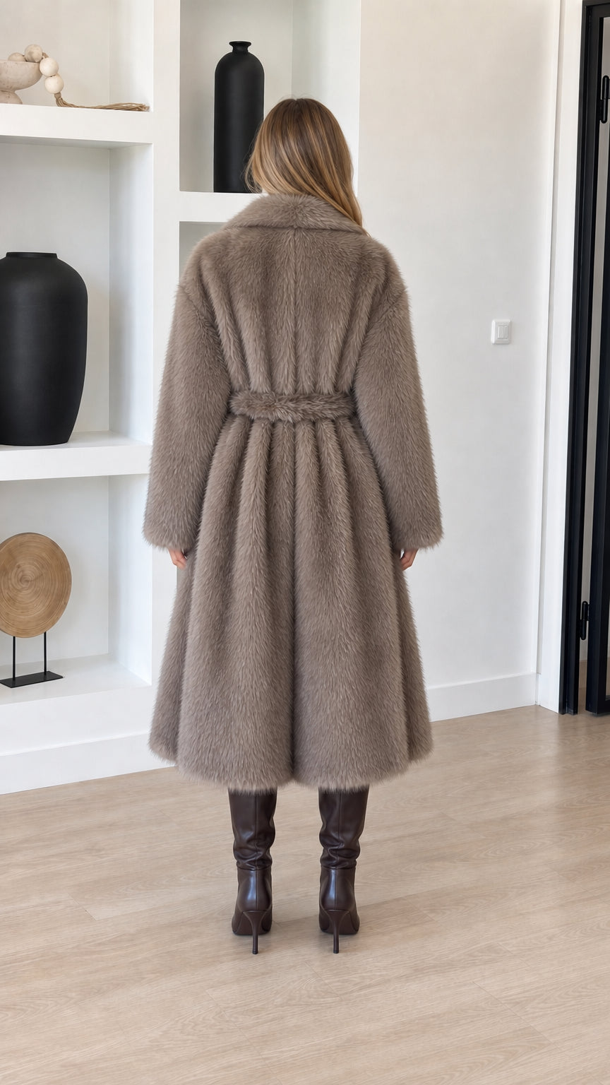 Back view of model in taupe belted faux fur coat highlighting waist definition