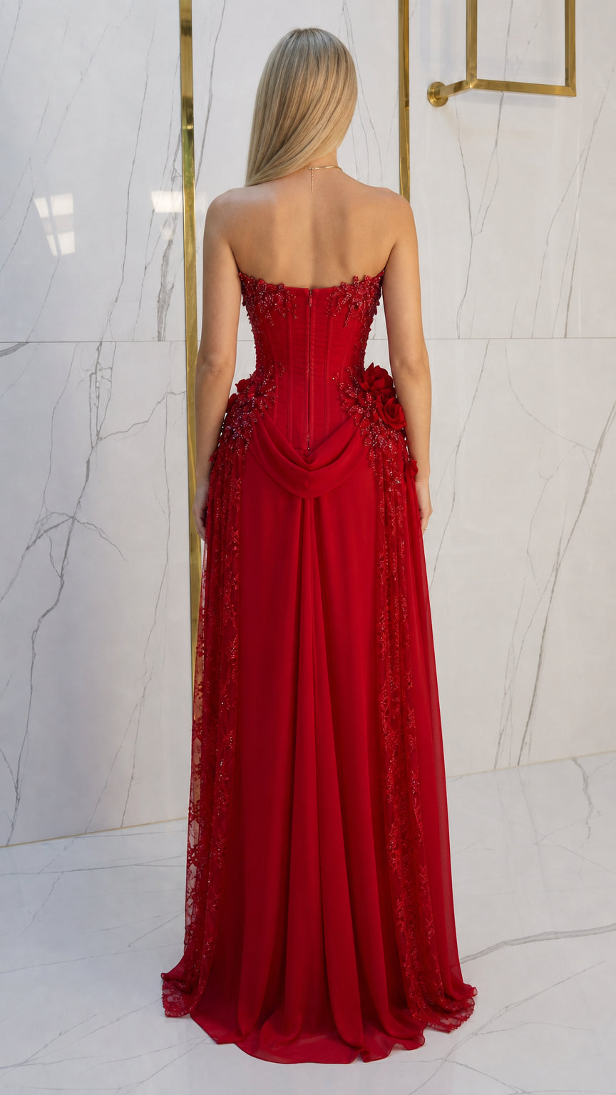Back view of red corset formal dress highlighting flowing floor-length train