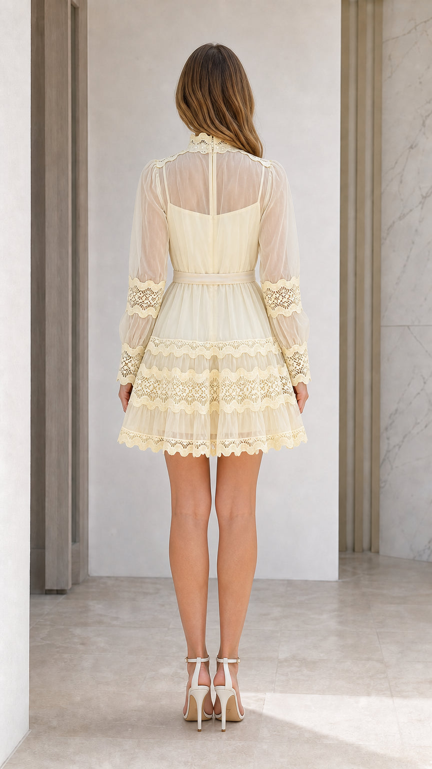 Back view of model wearing pale yellow long sleeve lace mini dress